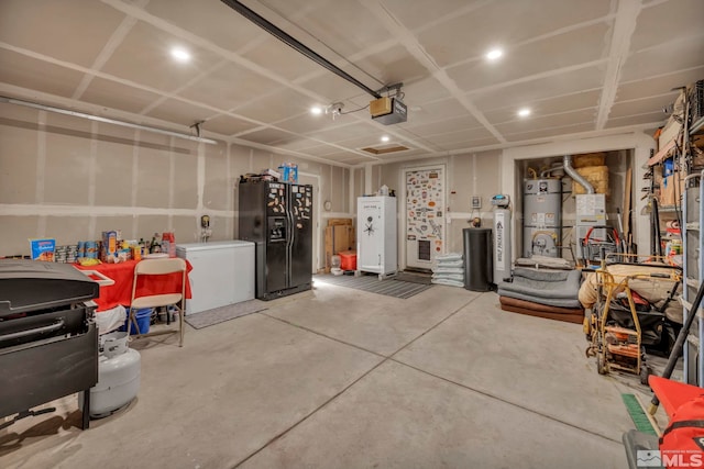 233 Jennys Ln, Fernley, NV 89408 - garage featuring black fridge with ice dispenser, secured water heater, refrigerator, a garage door opener, and recessed lighting