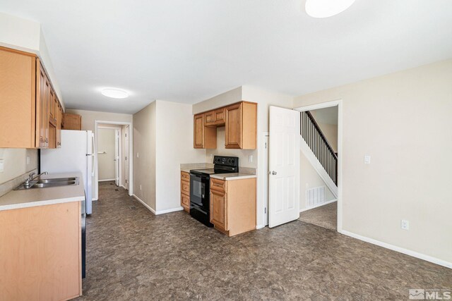 3924 Pheasant Dr, Carson City, NV 89701 - kitchen featuring black electric range, a sink, baseboards, and light countertops