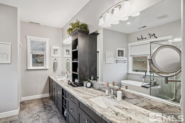 4610 Tybo Rd, Reno, NV 89521 - full bathroom featuring baseboards, double vanity, a soaking tub, and marble finish flooring