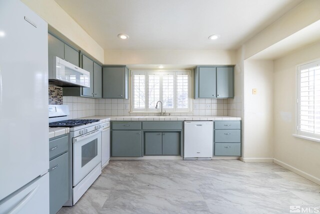 1784 Mahogany Cir, Minden, NV 89423 - kitchen with white appliances, light marble finish flooring, tile countertops, tasteful backsplash, and recessed lighting