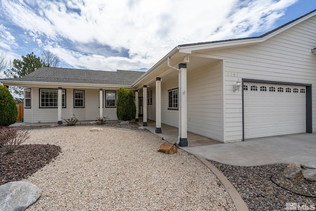 1147 Country Club Dr, Minden, NV 89423 - view of front of house with covered porch, driveway, and an attached garage