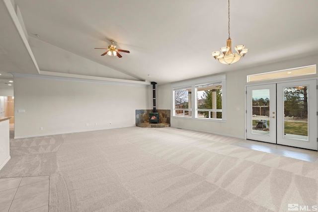 1147 Country Club Dr, Minden, NV 89423 - unfurnished living room featuring a wood stove, lofted ceiling, a chandelier, carpet, and baseboards