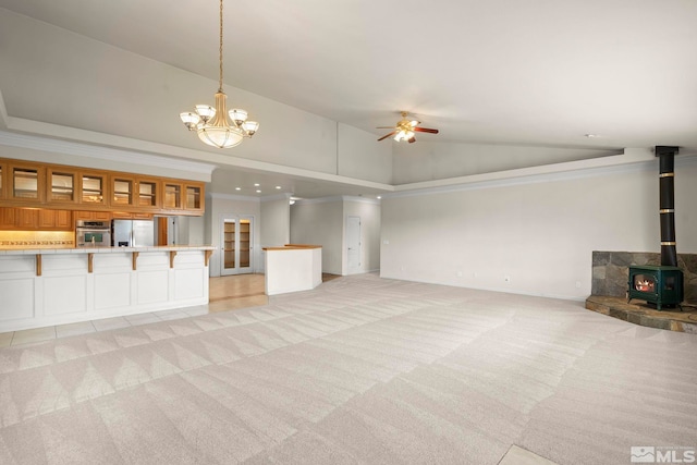 1147 Country Club Dr, Minden, NV 89423 - unfurnished living room featuring light colored carpet, a ceiling fan, a wood stove, crown molding, and baseboards