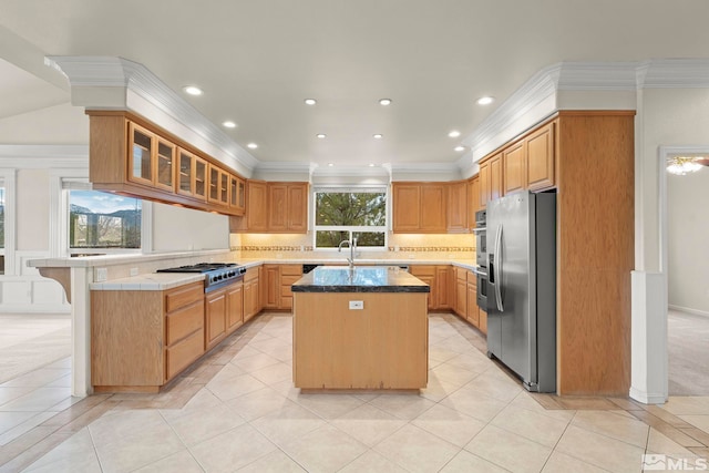 1147 Country Club Dr, Minden, NV 89423 - kitchen featuring stainless steel appliances, a peninsula, a kitchen island with sink, crown molding, and light tile patterned floors