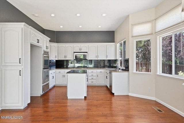 5024 E Albuquerque Rd, Reno, NV 89511 - kitchen featuring appliances with stainless steel finishes, white cabinetry, backsplash, and recessed lighting