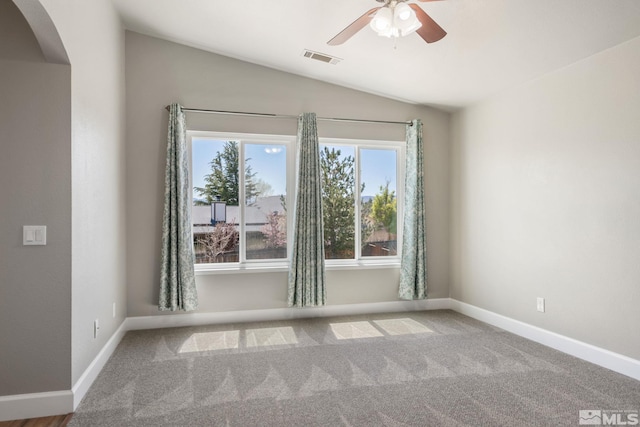 503 Windchase Dr, Dayton, NV 89403 - spare room with arched walkways, vaulted ceiling, a ceiling fan, carpet flooring, and baseboards