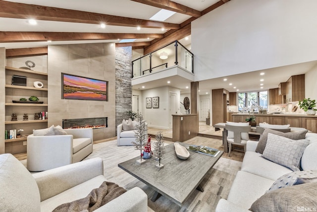 150 Juanita Unit 2, Incline Village, NV 89451 - living area with light wood finished floors, a tiled fireplace, high vaulted ceiling, recessed lighting, and baseboards