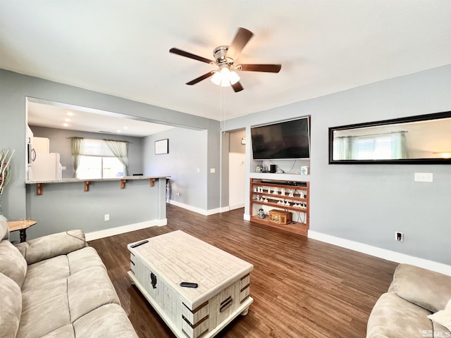 1480 Shadow Ln, Fernley, NV 89408 - living room featuring a ceiling fan, dark wood-style floors, and baseboards