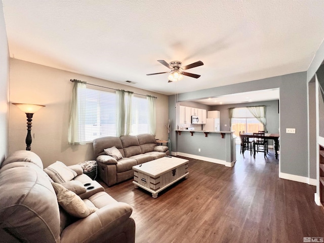 1480 Shadow Ln, Fernley, NV 89408 - living area with a ceiling fan, dark wood-type flooring, and baseboards