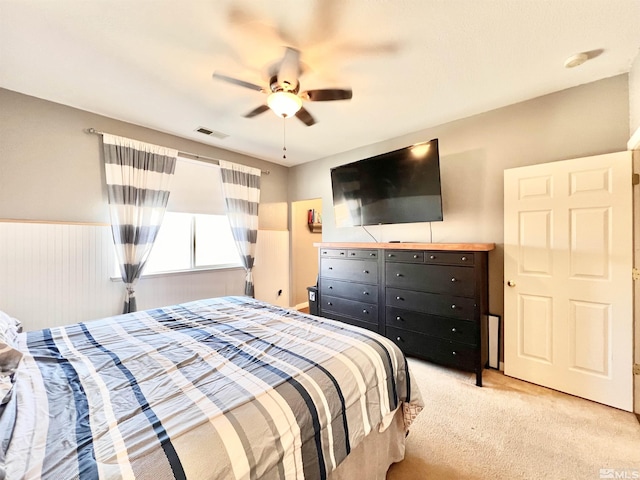 1480 Shadow Ln, Fernley, NV 89408 - bedroom featuring light carpet, a ceiling fan, and wainscoting