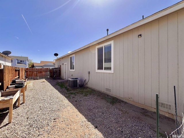 1480 Shadow Ln, Fernley, NV 89408 - view of side of home featuring fence, central AC, and crawl space
