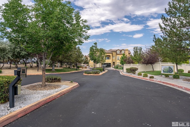 1325 S Meadows Pkwy Unit 322, Reno, NV 89521 - view of asphalt road featuring curbs, a gated entry, sidewalks, a residential view, and a gate