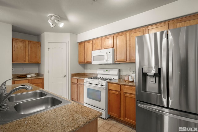 1325 S Meadows Pkwy Unit 322, Reno, NV 89521 - kitchen featuring white appliances, a sink, and brown cabinets