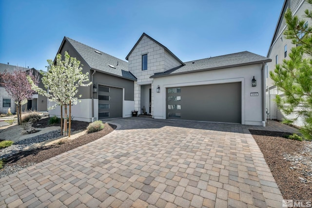 5469 Side Saddle Trl, Reno, NV 89511 - view of front of property with an attached garage, decorative driveway, a shingled roof, and stucco siding