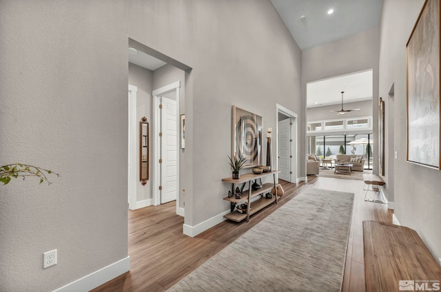 5469 Side Saddle Trl, Reno, NV 89511 - hallway featuring wood finished floors, baseboards, and a high ceiling