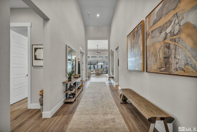 5469 Side Saddle Trl, Reno, NV 89511 - hall featuring wood finished floors, baseboards, and a high ceiling