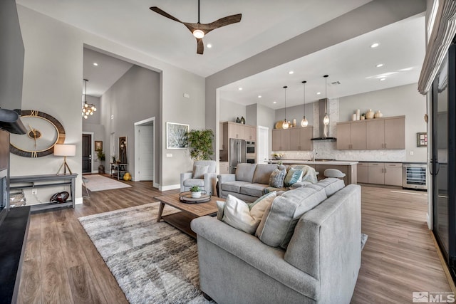 5469 Side Saddle Trl, Reno, NV 89511 - living area with beverage cooler, recessed lighting, a towering ceiling, wood finished floors, and a ceiling fan