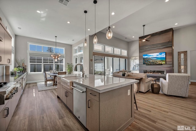5469 Side Saddle Trl, Reno, NV 89511 - kitchen with appliances with stainless steel finishes, a sink, wood finished floors, a spacious island, and recessed lighting