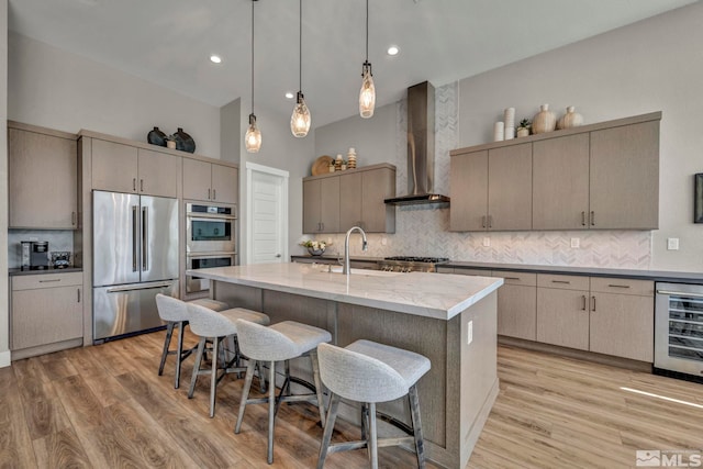 5469 Side Saddle Trl, Reno, NV 89511 - kitchen featuring appliances with stainless steel finishes, wall chimney exhaust hood, wine cooler, a sink, and a kitchen bar