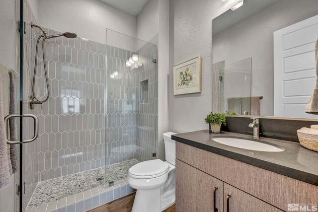 5469 Side Saddle Trl, Reno, NV 89511 - full bathroom featuring vanity, a stall shower, toilet, and wood finished floors