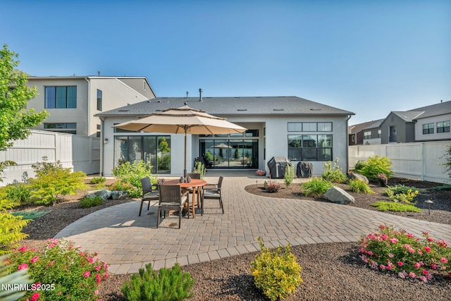5469 Side Saddle Trl, Reno, NV 89511 - back of property with stucco siding, a patio, a fenced backyard, and outdoor dining area