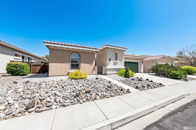 1510 Corleone Dr, Sparks, NV 89434 - mediterranean / spanish home with a garage, stucco siding, a tile roof, and fence