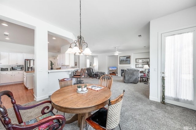 1510 Corleone Dr, Sparks, NV 89434 - dining area featuring a ceiling fan, light colored carpet, recessed lighting, and a chandelier
