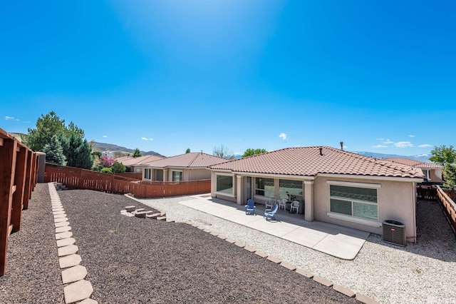 1510 Corleone Dr, Sparks, NV 89434 - rear view of house featuring a tiled roof, stucco siding, a fenced backyard, and a patio area