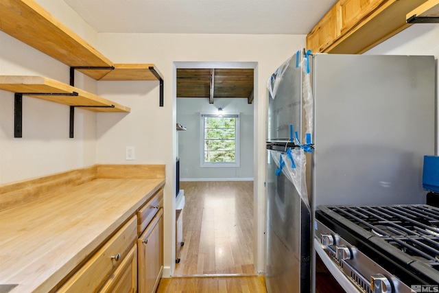 40 Shay Creek Rd, Markleeville, CA 96120 - kitchen featuring appliances with stainless steel finishes, open shelves, light wood-style flooring, and beamed ceiling