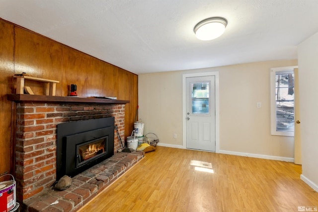 40 Shay Creek Rd, Markleeville, CA 96120 - unfurnished living room featuring light wood-style flooring, a brick fireplace, and baseboards