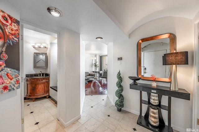 280 Island Ave Unit 904, Reno, NV 89501 - corridor featuring arched walkways, baseboards, light marble finish flooring, and a sink