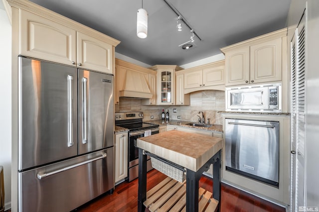 280 Island Ave Unit 904, Reno, NV 89501 - kitchen with cream cabinets, appliances with stainless steel finishes, custom range hood, a sink, and light stone counters