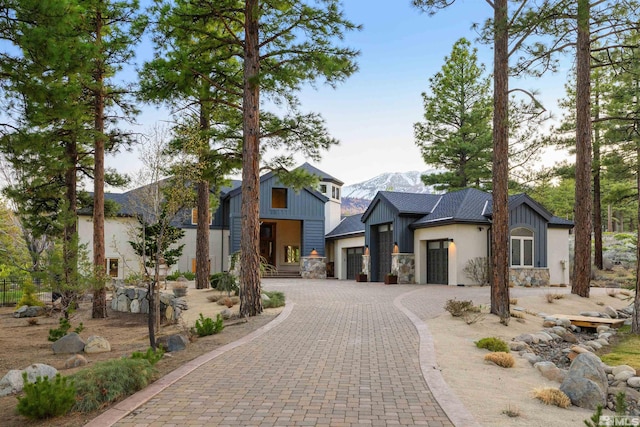 120 W Willis Ln, Reno, NV 89511 - modern home featuring stone siding, a mountain view, an attached garage, and driveway