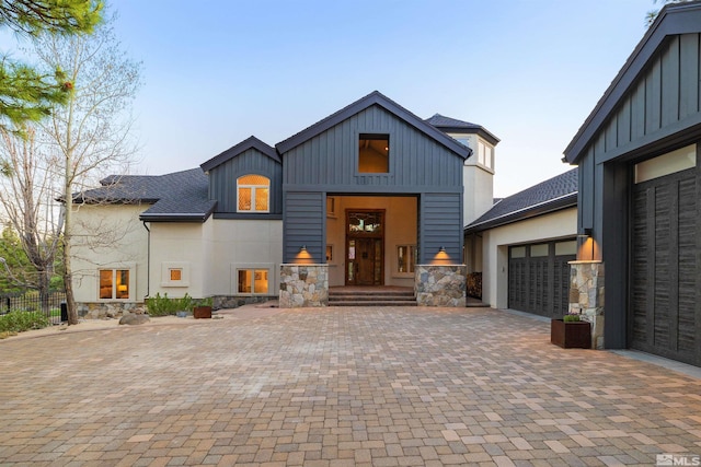 120 W Willis Ln, Reno, NV 89511 - view of front facade with stone siding, an attached garage, decorative driveway, and board and batten siding