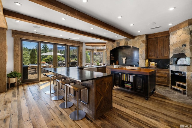 120 W Willis Ln, Reno, NV 89511 - kitchen featuring a large island with sink, a sink, beam ceiling, wood-type flooring, and recessed lighting