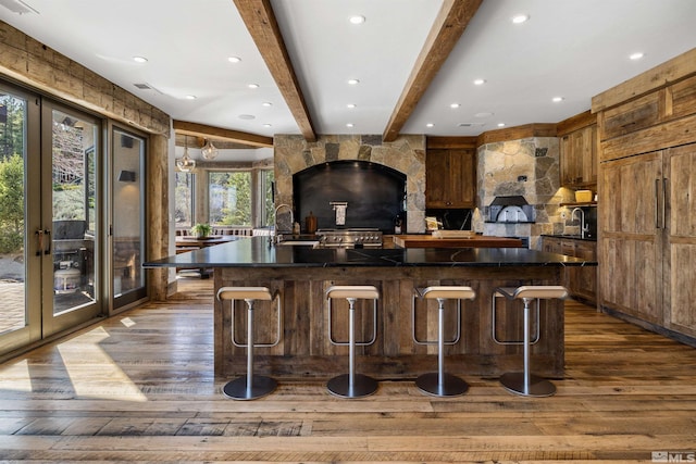 120 W Willis Ln, Reno, NV 89511 - kitchen with dark countertops, dark wood-style floors, french doors, beam ceiling, and a large island