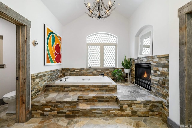 120 W Willis Ln, Reno, NV 89511 - bathroom with a fireplace, a chandelier, a garden tub, toilet, and high vaulted ceiling