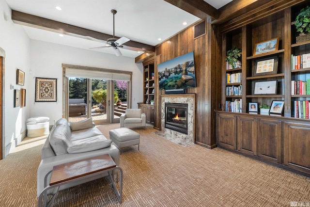 120 W Willis Ln, Reno, NV 89511 - living room featuring light colored carpet, ceiling fan, a premium fireplace, beamed ceiling, and built in shelves