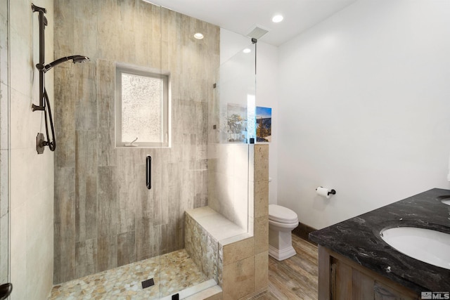 120 W Willis Ln, Reno, NV 89511 - bathroom with a stall shower, toilet, wood finished floors, and double vanity