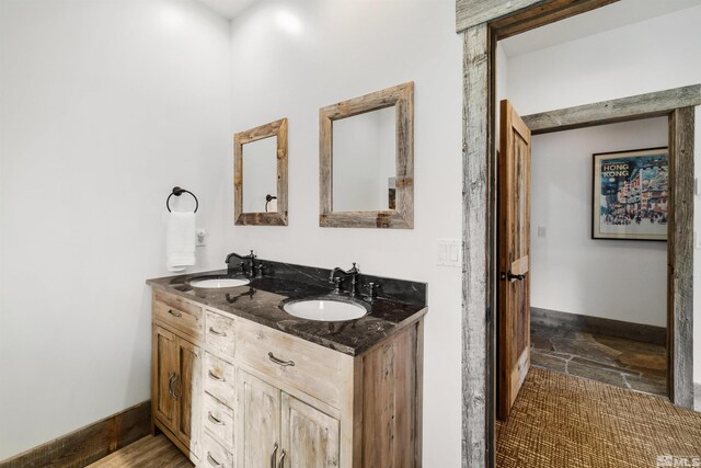 120 W Willis Ln, Reno, NV 89511 - bathroom featuring baseboards, double vanity, and stone finish flooring