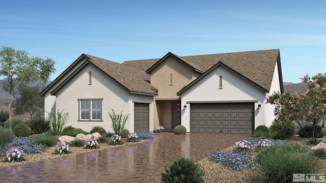 3237 Amaretto Way Unit Cinmon 64, Sparks, NV 89441 - view of front of house featuring a garage, decorative driveway, stucco siding, and roof with shingles
