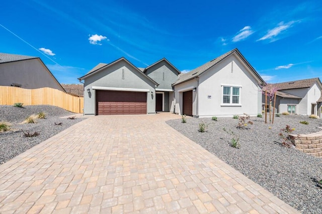 3237 Amaretto Way Unit Cinmon 64, Sparks, NV 89441 - ranch-style house featuring an attached garage, decorative driveway, fence, and stucco siding