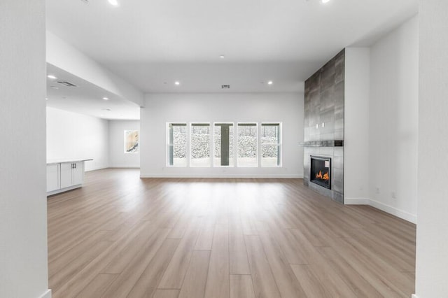 3237 Amaretto Way Unit Cinmon 64, Sparks, NV 89441 - unfurnished living room featuring plenty of natural light, a fireplace, recessed lighting, light wood finished floors, and baseboards