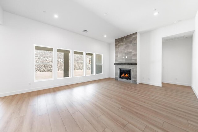 3237 Amaretto Way Unit Cinmon 64, Sparks, NV 89441 - unfurnished living room featuring light wood-style flooring, a large fireplace, baseboards, and recessed lighting