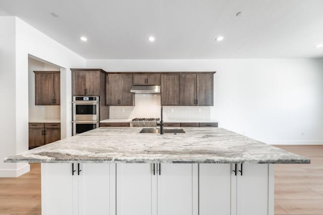 3237 Amaretto Way Unit Cinmon 64, Sparks, NV 89441 - kitchen featuring a sink, double oven, a large island, backsplash, and recessed lighting