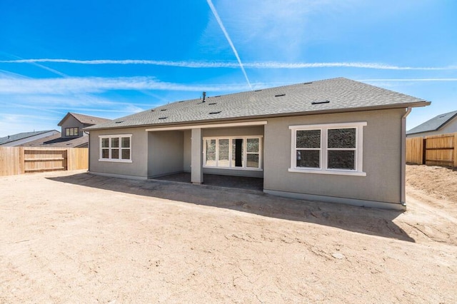 3237 Amaretto Way Unit Cinmon 64, Sparks, NV 89441 - back of property with a fenced backyard, a patio area, and roof with shingles