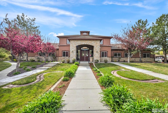 6850 Sharlands Ave Unit A2003, Reno, NV 89523 - view of front of house with stucco siding, stone siding, and a front lawn