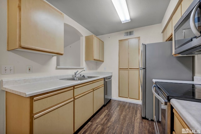 6850 Sharlands Ave Unit A2003, Reno, NV 89523 - kitchen featuring stainless steel appliances, a sink, dark wood finished floors, light countertops, and cream cabinetry