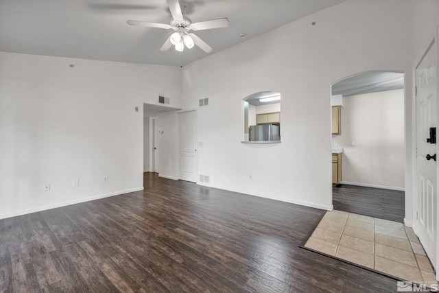 6850 Sharlands Ave Unit A2003, Reno, NV 89523 - spare room with arched walkways, wood finished floors, a ceiling fan, baseboards, and high vaulted ceiling