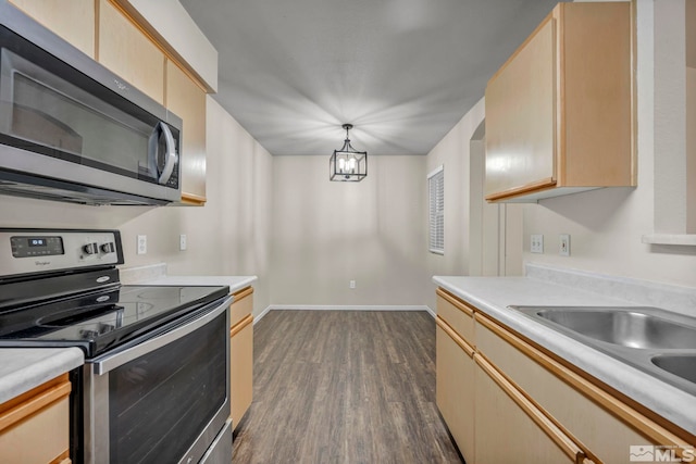 6850 Sharlands Ave Unit A2003, Reno, NV 89523 - kitchen featuring appliances with stainless steel finishes, dark wood-type flooring, light countertops, light brown cabinets, and hanging light fixtures
